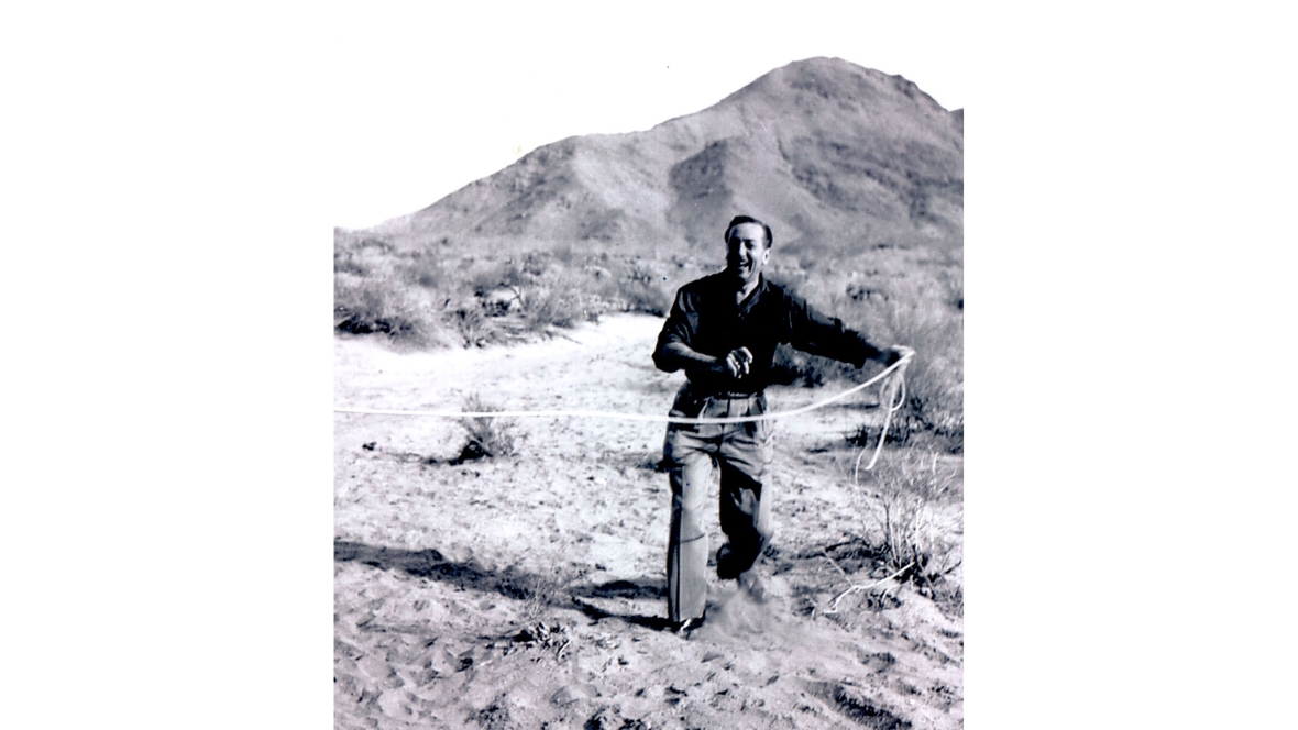In an archival image, Walt Disney plans out the spot for his Smoke Tree Ranch vacation home in Palm Springs with measuring tape.