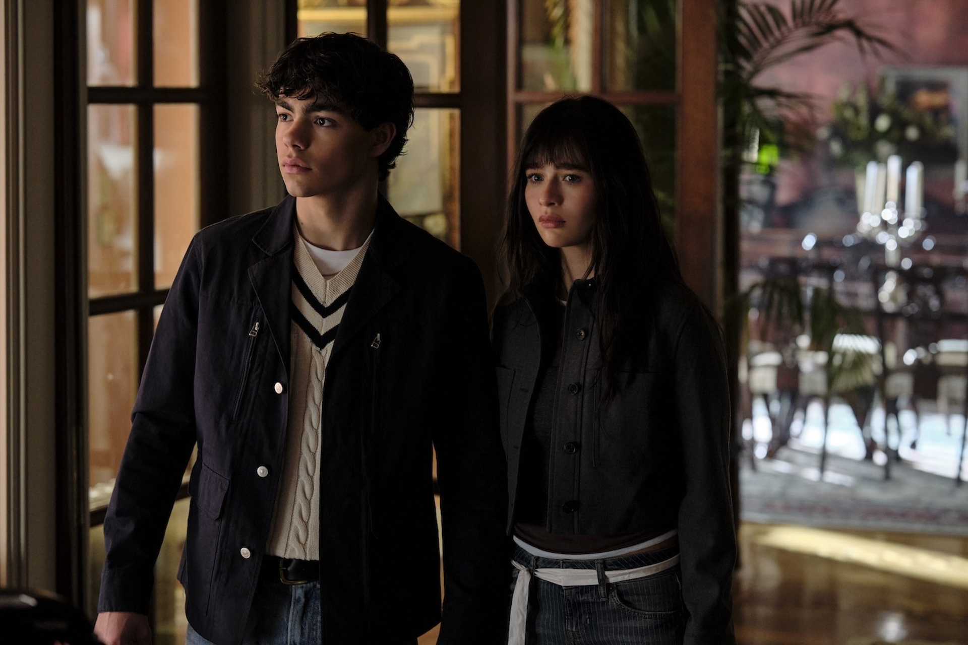 Jake, played by Malachi Barton, and Briar, played by Malina Weissman, stand side-by-side in the hallway in a scene from Disney&rsquo;s Coven Academy.