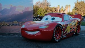 A Lightning McQueen display vehicle from Disney and Pixar&rsquo;s Cars is showcased outdoors during a fan event experience.