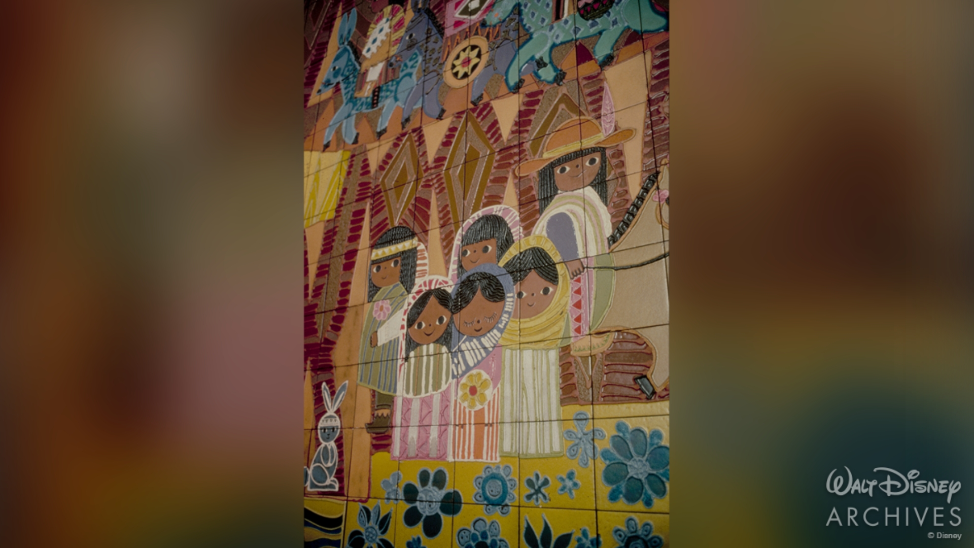 A close view of a section of the colorful Grand Canyon Concourse. This section of the mural features six Native American children dressed in traditional clothing. 
