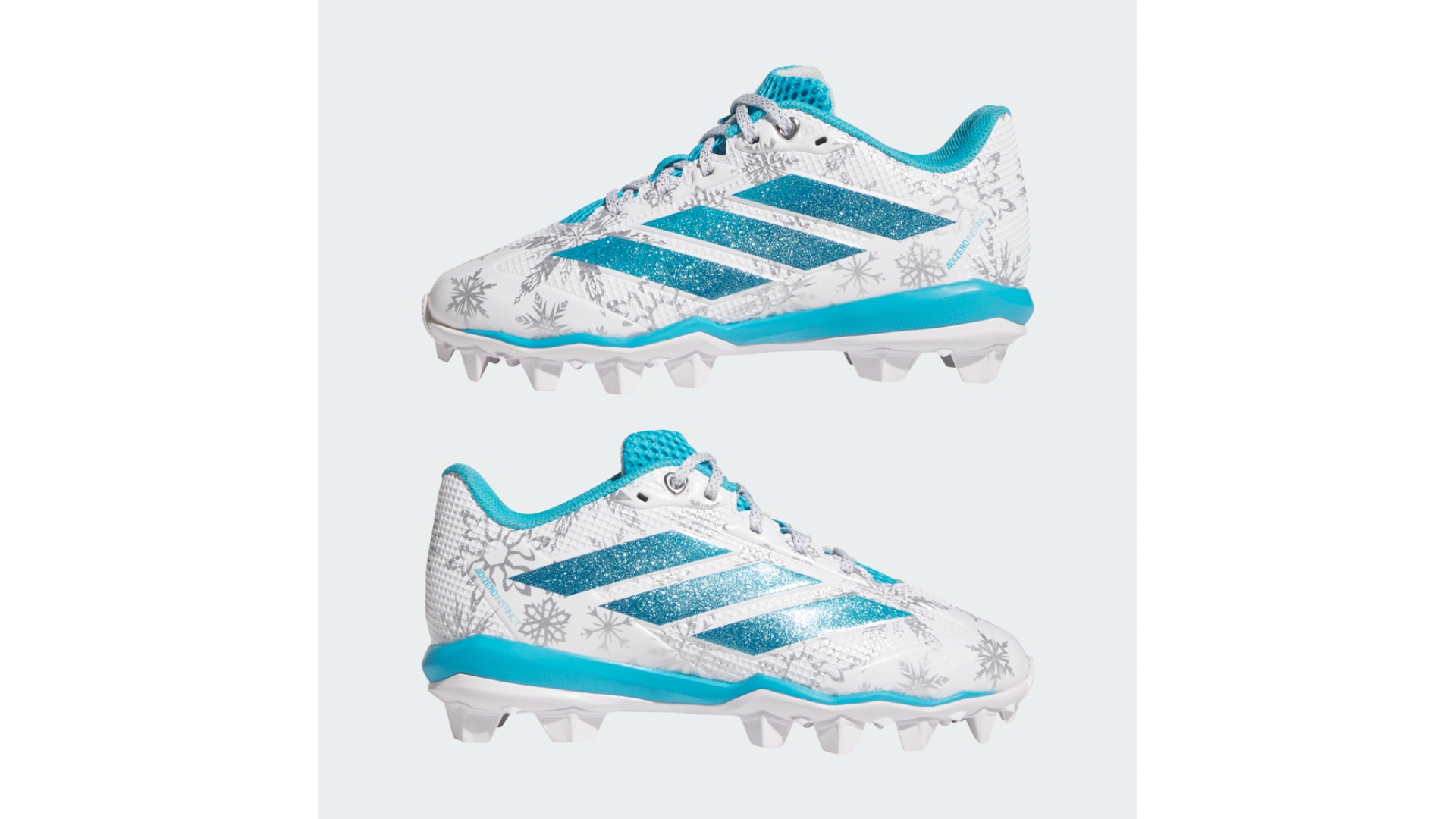 Pair of Frozen-inspired Adidas cleats featuring icy blue accents, glittery stripes, and snowflake graphics on a white background.