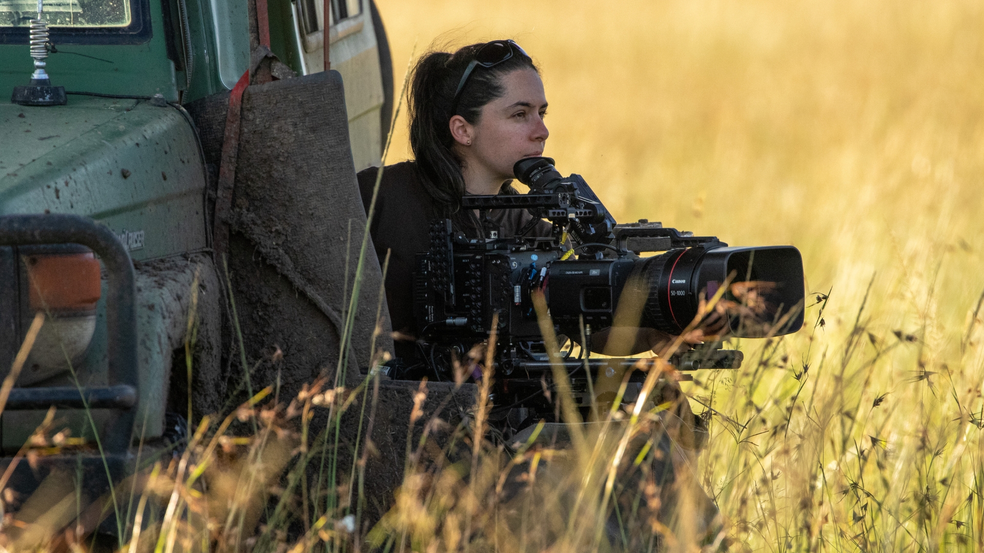 In an image taken during production of National Geographic’s LION, cinematographer Tania Escobar is seen looking out into the distance at Summer’s pride, ready to begin filming as soon as the action starts to unfold.
