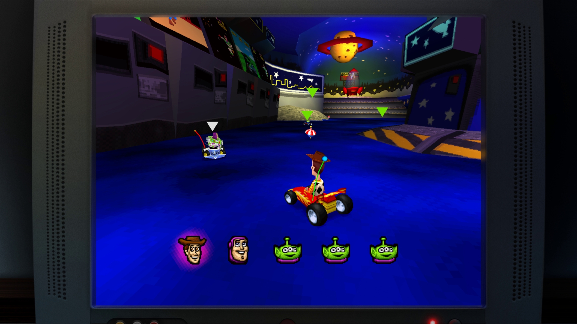 In-game video screenshot showing Woody and Buzz racing small karts on a blue track inside a space-themed room.