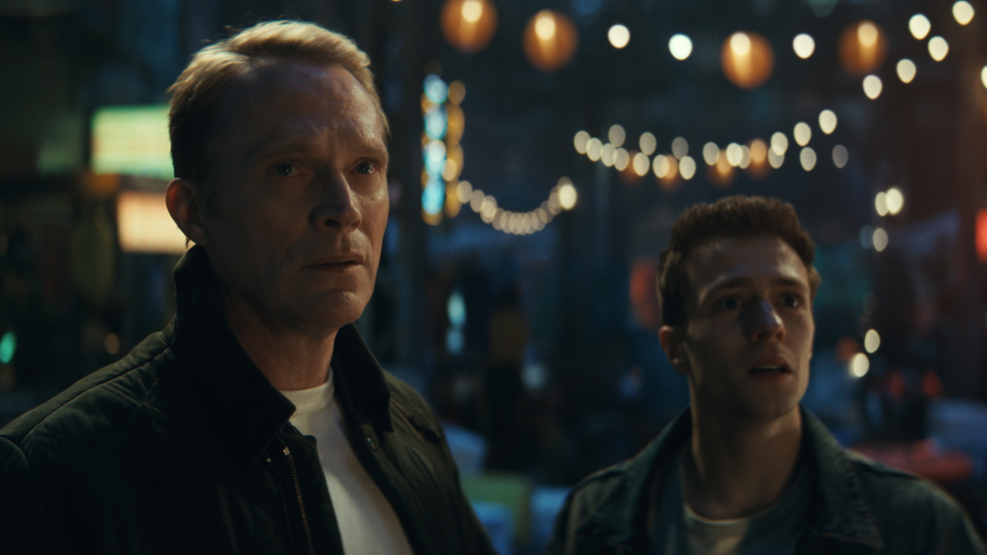 In this scene from Marvel Television&rsquo;s VisionQuest, Vision, played by Paul Bettany, and Thomas Shepherd, played by Ruaridh Mollica, appear in a night market in Madripoor.