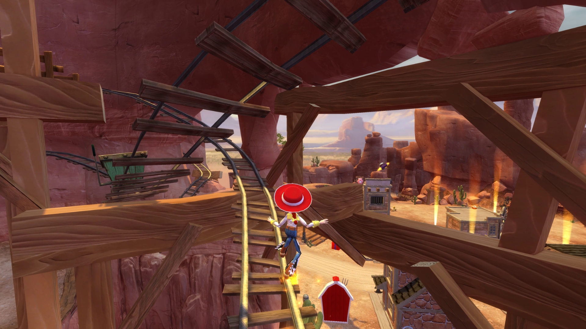 Jessie balances on winding mine cart tracks above a desert canyon in Toy Story 3 Complete Edition.