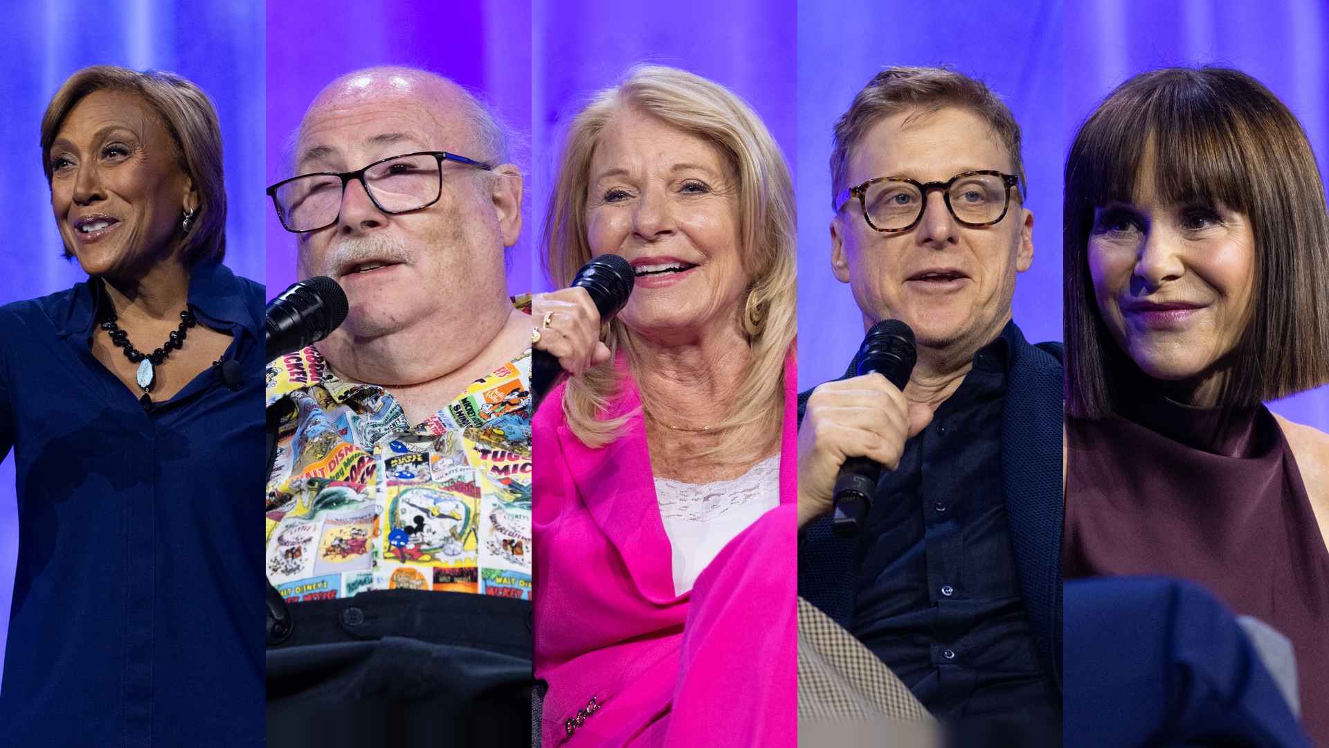 Five speakers hold microphones and participate in a panel discussion during a D23 event.